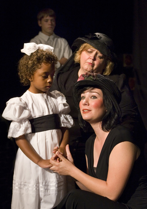 Leilani McAllister as The Girl, Cynthia Meier as The Mother, 
        Laine Peterson as The Stepdaughter, and Connor Foster as The Boy (background)